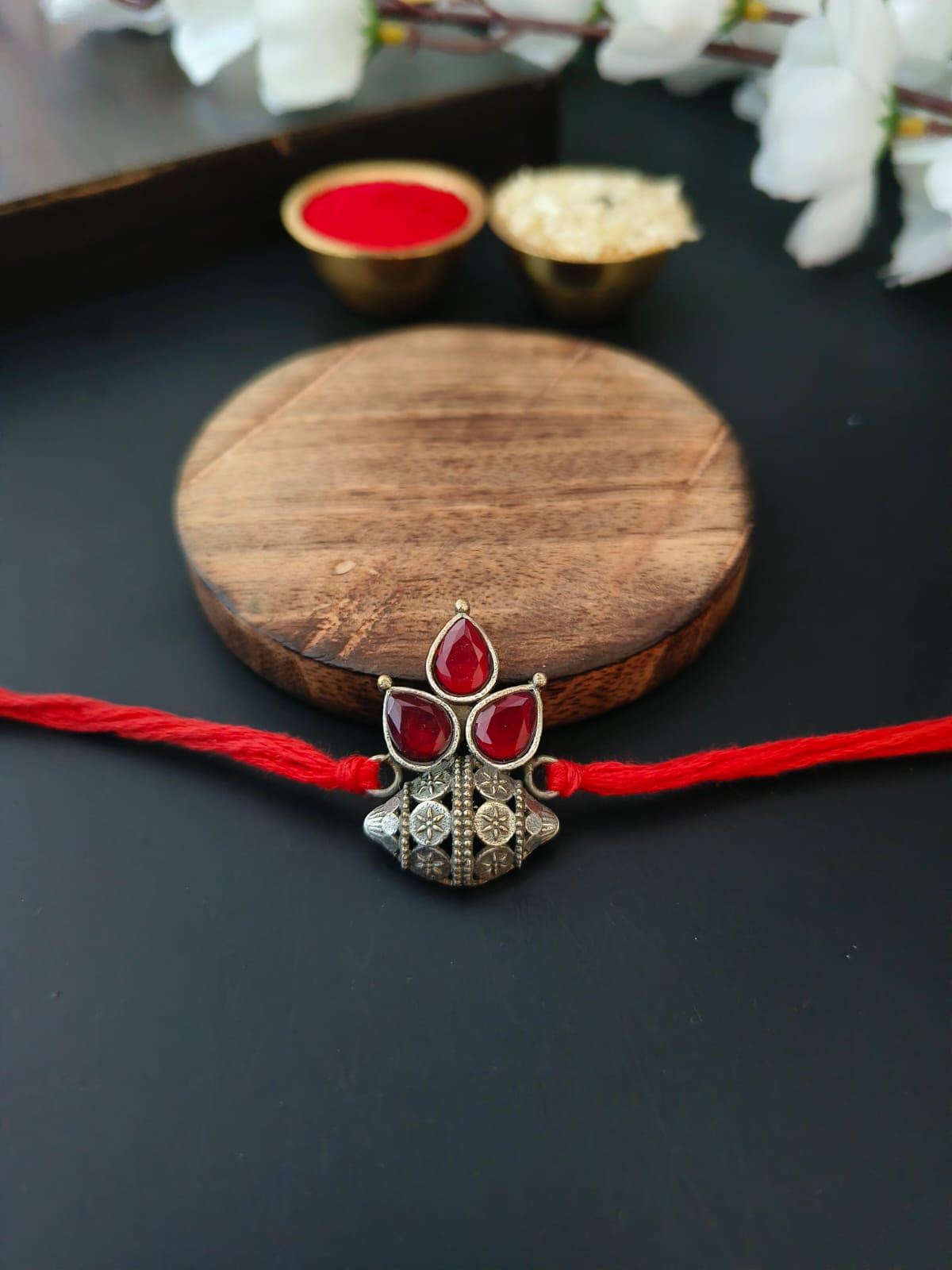Floral Dome Rakhi with Red Stones & Silver Polish | Dynamic Jewelove